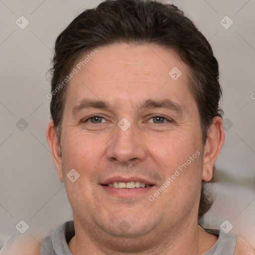 Joyful white adult male with short  brown hair and brown eyes