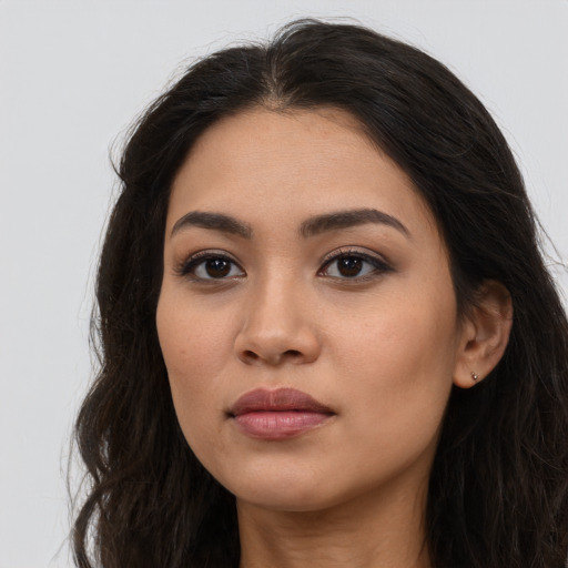 Neutral latino young-adult female with long  brown hair and brown eyes
