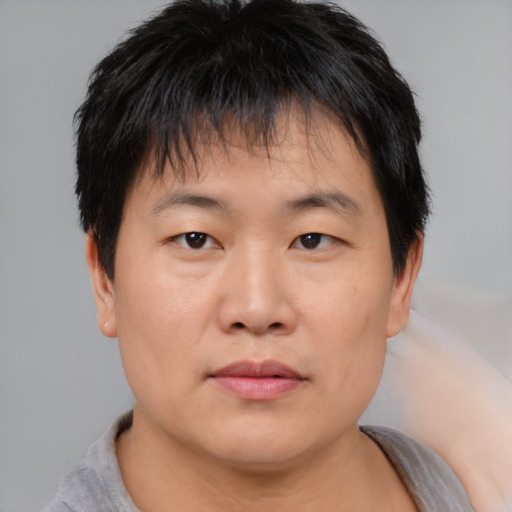 Neutral asian young-adult male with short  brown hair and brown eyes