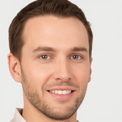 Joyful white young-adult male with short  brown hair and brown eyes