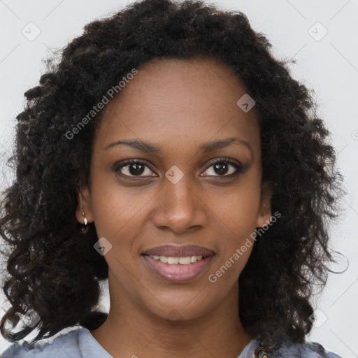 Joyful black young-adult female with long  brown hair and brown eyes