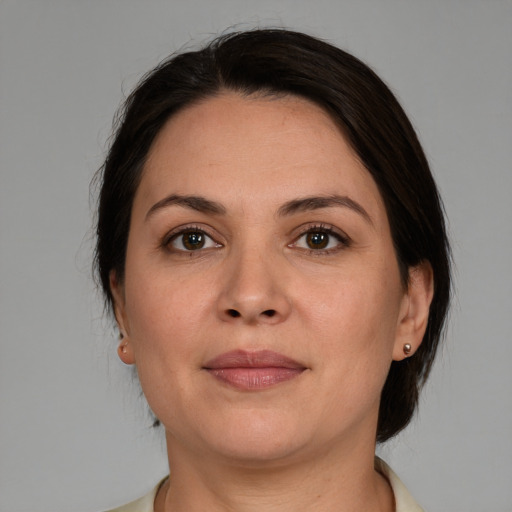 Joyful white adult female with medium  brown hair and brown eyes