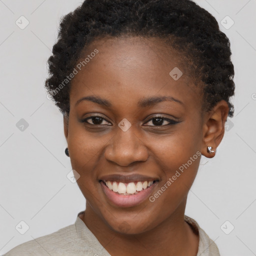 Joyful black young-adult female with short  brown hair and brown eyes