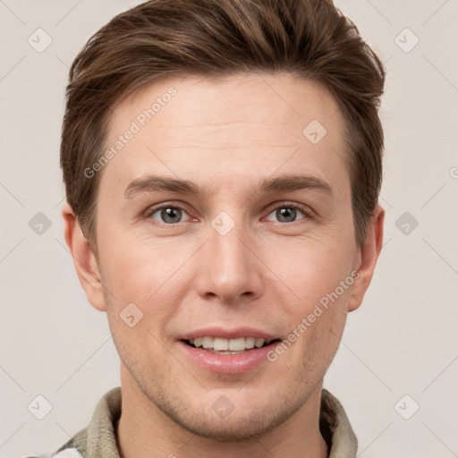 Joyful white young-adult male with short  brown hair and grey eyes