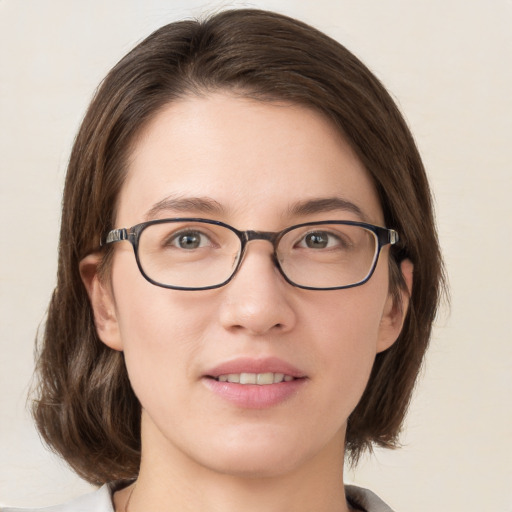 Joyful white young-adult female with medium  brown hair and green eyes