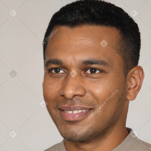 Joyful black young-adult male with short  black hair and brown eyes