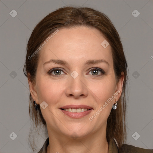 Joyful white adult female with medium  brown hair and grey eyes