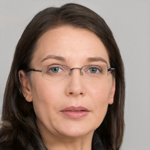 Joyful white adult female with long  brown hair and grey eyes