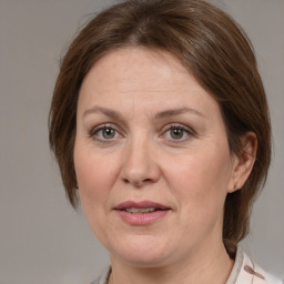 Joyful white adult female with medium  brown hair and grey eyes