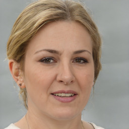 Joyful white adult female with medium  brown hair and brown eyes