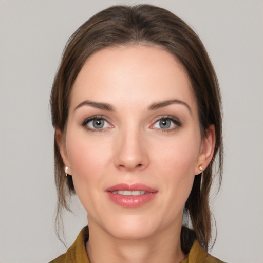 Joyful white young-adult female with medium  brown hair and grey eyes