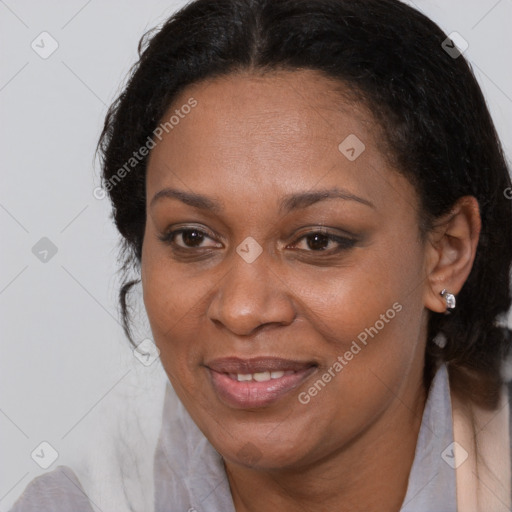 Joyful black adult female with medium  brown hair and brown eyes