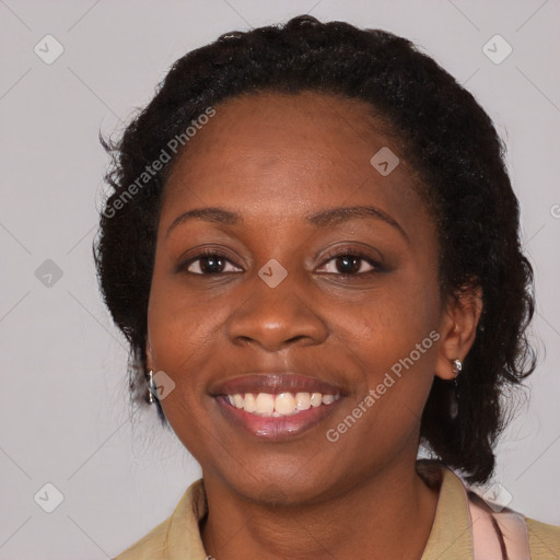 Joyful black adult female with medium  brown hair and brown eyes