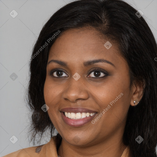 Joyful black young-adult female with long  brown hair and brown eyes