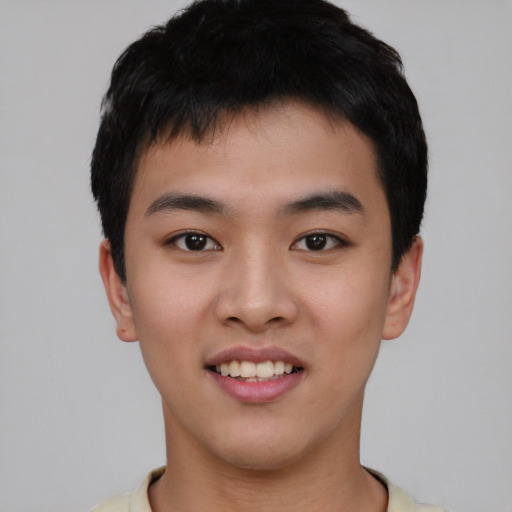 Joyful asian young-adult male with short  black hair and brown eyes