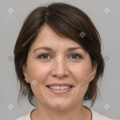 Joyful white adult female with medium  brown hair and brown eyes