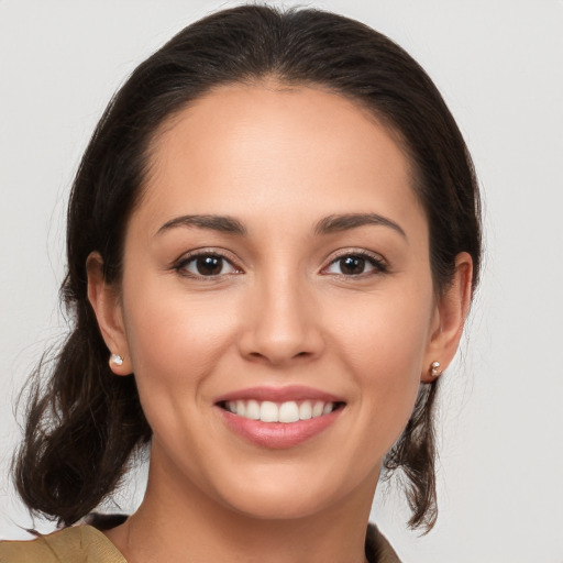 Joyful white young-adult female with medium  brown hair and brown eyes