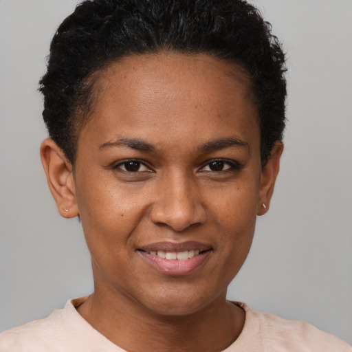 Joyful black young-adult female with short  brown hair and brown eyes