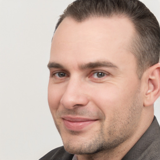 Joyful white adult male with short  brown hair and brown eyes