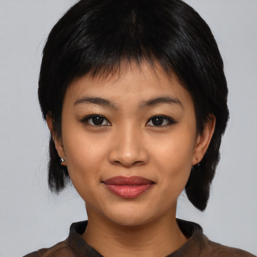 Joyful asian young-adult female with medium  black hair and brown eyes