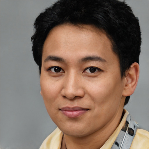 Joyful latino young-adult male with short  brown hair and brown eyes