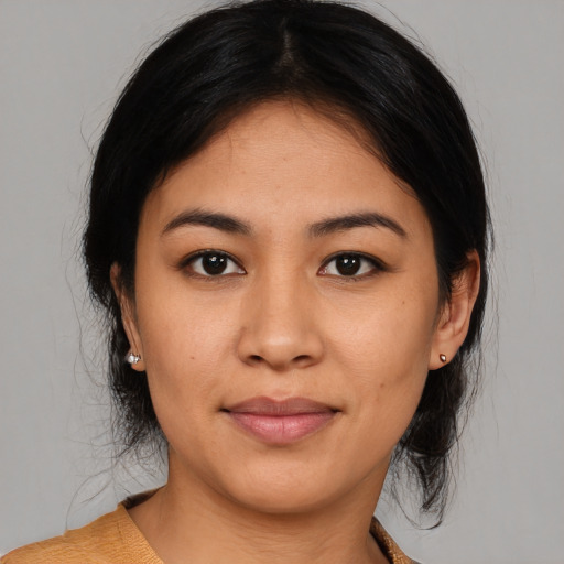 Joyful latino young-adult female with medium  black hair and brown eyes