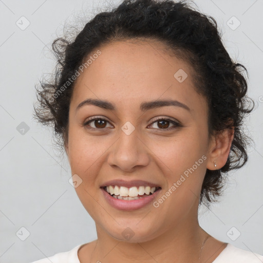 Joyful latino young-adult female with short  brown hair and brown eyes