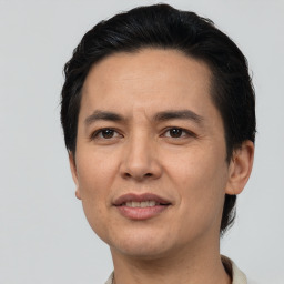 Joyful asian adult male with short  black hair and brown eyes