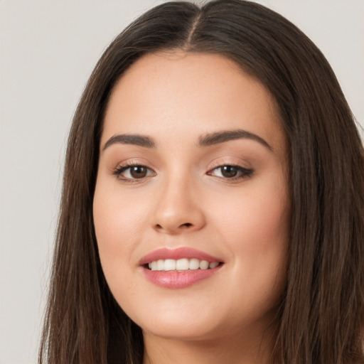 Joyful white young-adult female with long  brown hair and brown eyes