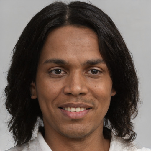 Joyful black adult male with medium  brown hair and brown eyes