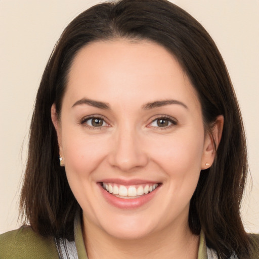 Joyful white young-adult female with long  brown hair and brown eyes