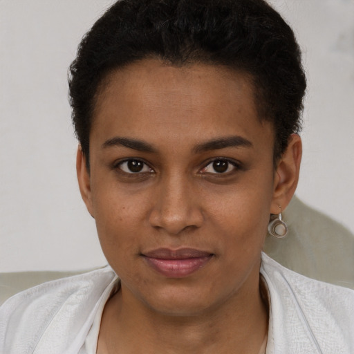 Joyful black young-adult female with short  brown hair and brown eyes
