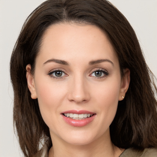 Joyful white young-adult female with long  brown hair and brown eyes