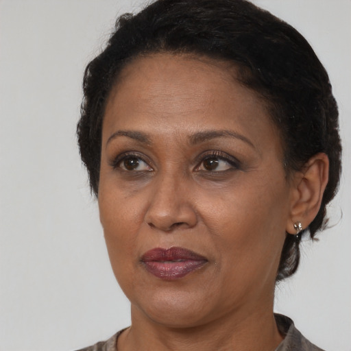 Joyful black adult female with short  brown hair and brown eyes
