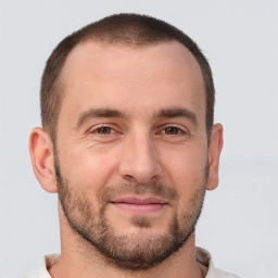 Joyful white adult male with short  brown hair and brown eyes