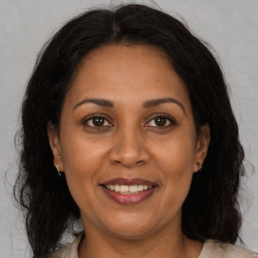 Joyful black adult female with medium  brown hair and brown eyes