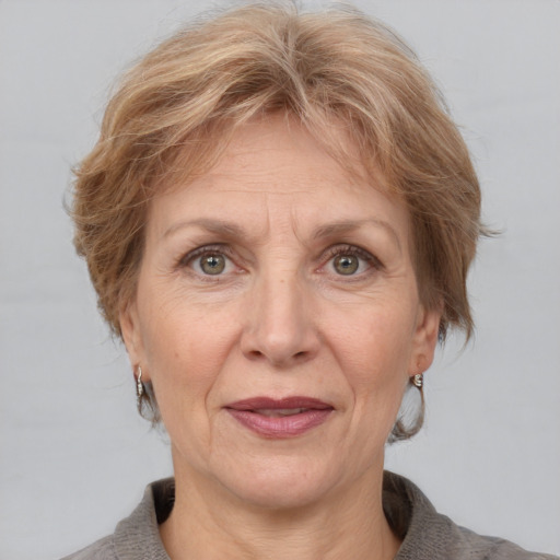 Joyful white middle-aged female with medium  brown hair and grey eyes