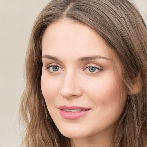 Joyful white young-adult female with long  brown hair and green eyes