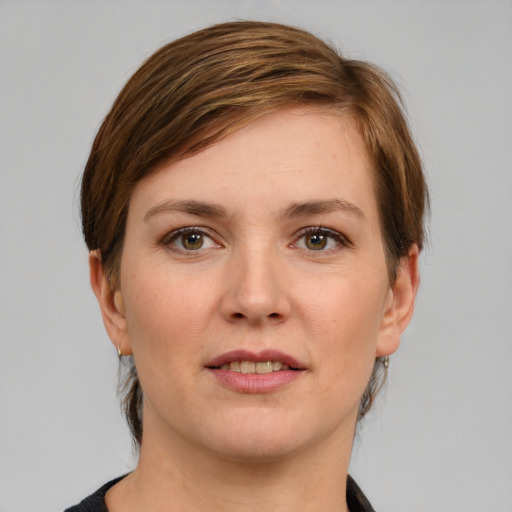 Joyful white young-adult female with short  brown hair and grey eyes