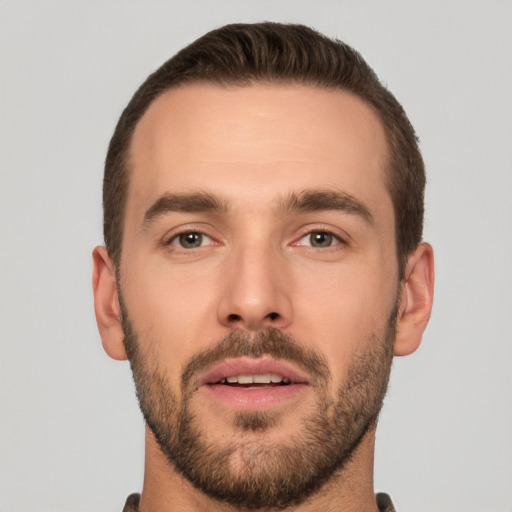 Joyful white young-adult male with short  brown hair and brown eyes