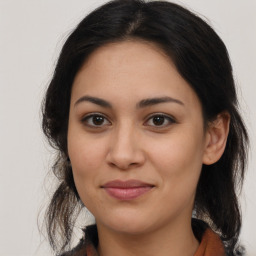 Joyful latino young-adult female with medium  brown hair and brown eyes