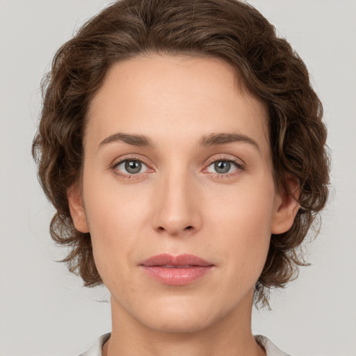 Joyful white young-adult female with medium  brown hair and green eyes