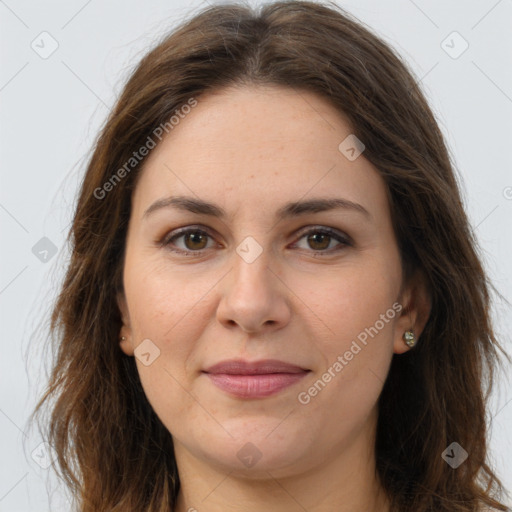 Joyful white adult female with long  brown hair and brown eyes