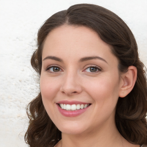 Joyful white young-adult female with medium  brown hair and blue eyes