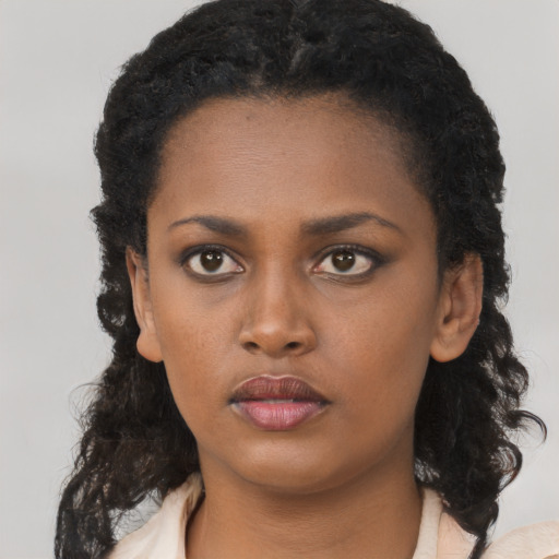 Neutral black young-adult female with medium  black hair and brown eyes