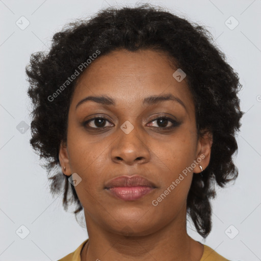 Joyful black adult female with short  brown hair and brown eyes