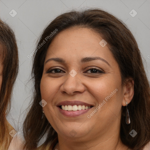 Joyful white adult female with long  brown hair and brown eyes