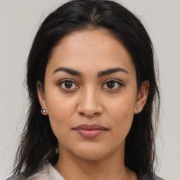 Joyful latino young-adult female with medium  brown hair and brown eyes