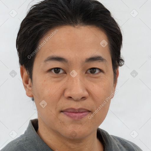 Joyful asian adult male with short  brown hair and brown eyes