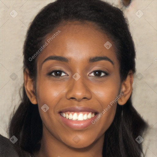 Joyful black young-adult female with long  brown hair and brown eyes